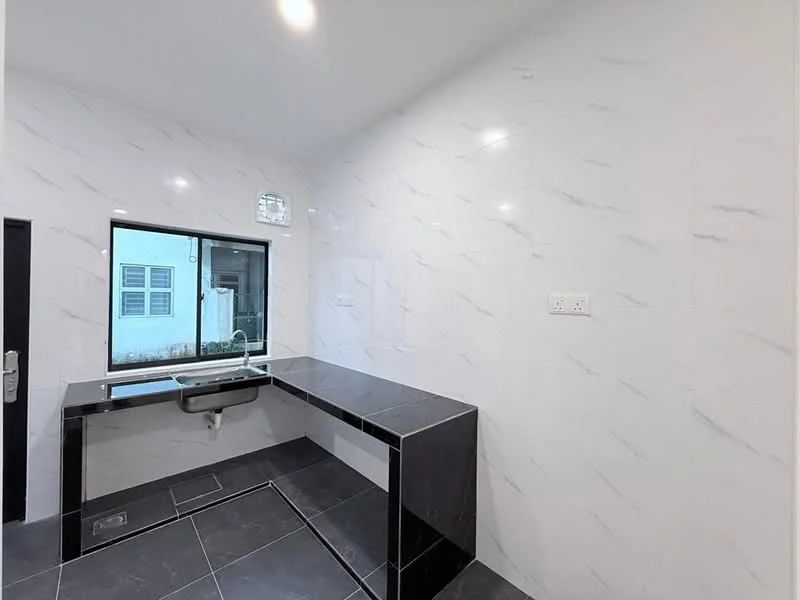 Laundry features: black countertop, white marble tile walls, black tile flooring, single-bowl stainless-steel sink, window with view to exterior, wall-mounted electrical outlet, built-in cabinetry, recessed ceiling lights; style: modern.