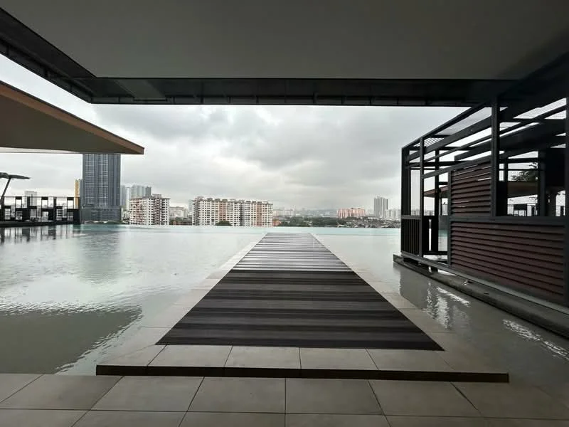 Exterior type: swimming pool deck; features: infinity pool, wooden deck walkway, surrounding city skyline, modern architectural design, outdoor seating area, landscaped surroundings; style: modern.