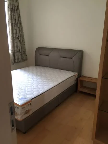 Bedroom features: queen-size bed with upholstered headboard, light wood bedside table, laminate flooring, white painted walls, curtains with geometric pattern, window with natural light, mattress on bed frame; style: modern.