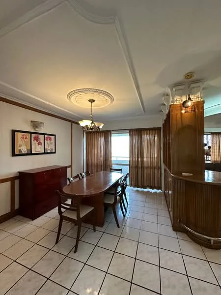 Dining features: square tile flooring, white painted walls with crown moulding, chandelier with multiple bulbs, decorative ceiling rose, wooden dining table, upholstered dining chairs, sideboard cabinet, floor-to-ceiling windows with sheer curtains, natural light from windows, wood paneling on one wall; style: traditional; view: city.