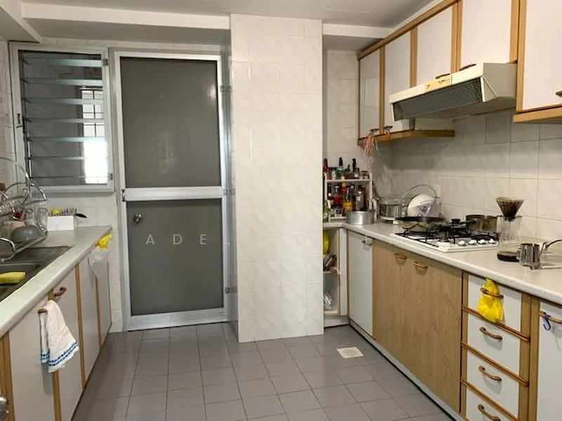 Kitchen features: white laminate cabinetry, grey tiled flooring, stainless-steel gas hob, stainless-steel range hood, double-bowl stainless-steel sink, wall-mounted cabinets, countertop with space for appliances, window with metal grille, kitchen utensils and condiments visible; style: modern.