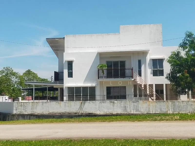 Exterior type: detached bungalow; features: white painted facade, flat roof, two-storey structure, balcony on upper level, large windows with horizontal slats, staircase leading to balcony, manicured lawn, surrounding greenery, concrete boundary wall, driveway in front; style: modern.