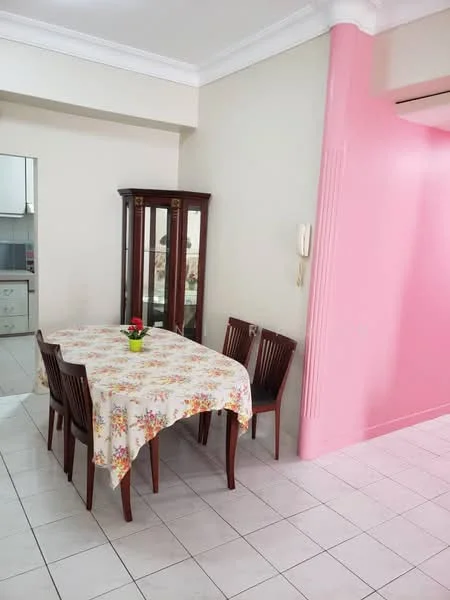Dining features: square dining table with floral tablecloth, 4 wooden dining chairs, glass display cabinet, pink accent wall, white tiled flooring, wall-mounted telephone, decorative plant on table. Room features: white painted walls, open layout to kitchen area.