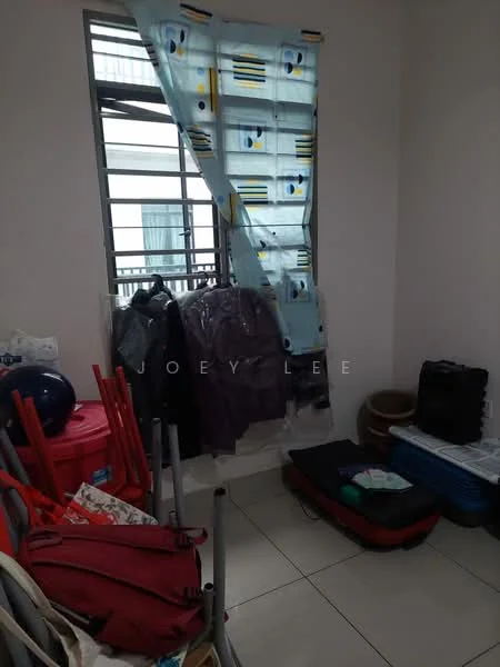 Room features: window with metal grille, curtains with geometric pattern, white painted walls, tile flooring, stacked chairs, luggage, clothes hanging on hooks, various bags and storage items.