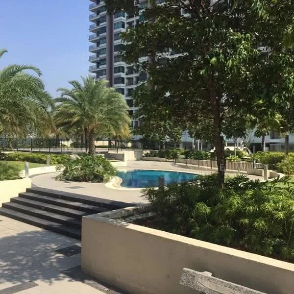 Exterior type: high-rise condominium; features: landscaped garden, swimming pool, palm trees, manicured lawn, stone-paved walkway, fenced perimeter, outdoor seating area; style: modern.