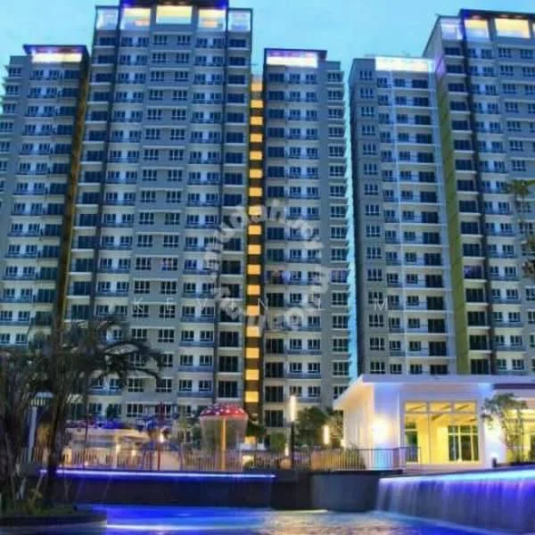 Exterior type: high-rise condominium; features: glass curtain wall, illuminated facade, multiple storeys, balconies on each floor, swimming pool in foreground, landscaped garden area, water feature, outdoor seating area, security guard house, parking area visible; style: modern.