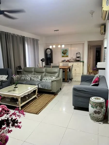 Living features: 3-seater fabric sofa in grey, 2-seater fabric sofa in dark grey, coffee table with white surface and wooden legs, area rug with natural fibers, ceiling fan, pendant lighting with multiple bulbs, floor-to-ceiling windows with sheer curtains, wall-mounted air conditioning unit, decorative vase, framed artwork on the wall, dining table with chairs visible in the background, light-colored walls, white tiled flooring; style: modern.