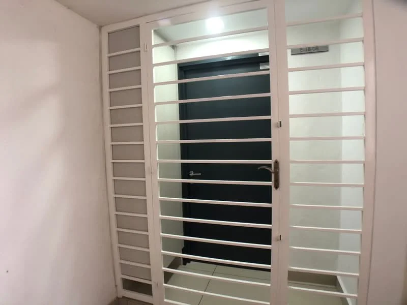 Room features: white metal security grille door, black main entrance door, light grey tiled flooring, white painted walls, overhead ceiling light; style: modern.