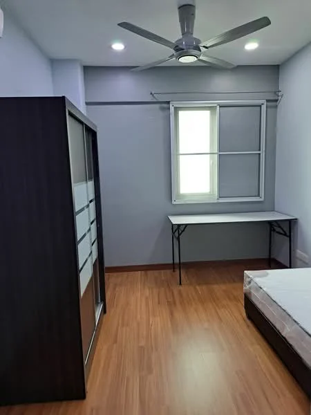 Bedroom features: laminate flooring, light grey painted walls, 5-blade ceiling fan with light, window with white frame, built-in wardrobe with sliding doors, folding table, queen-size bed frame without mattress; style: modern.