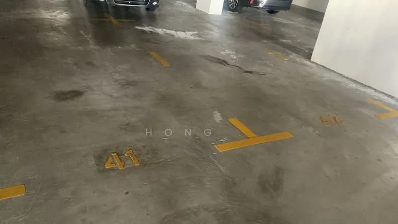 Exterior type: parking deck; features: concrete flooring, marked parking spaces, yellow parking lines, indoor lighting, vehicles parked, smooth surface, walls painted white; style: modern.