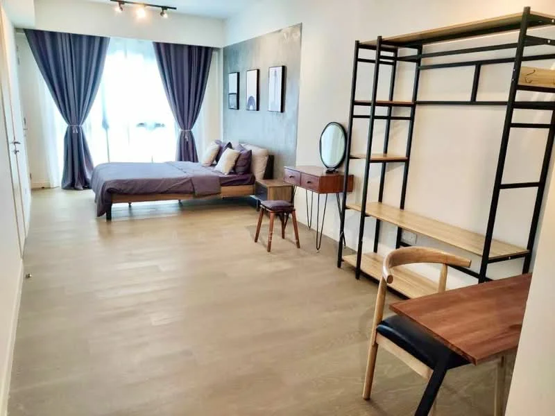 Bedroom features: queen-size bed with grey bedding, floor-to-ceiling windows with sheer curtains, wooden flooring, exposed concrete accent wall, black metal shelving unit, wooden desk with chair, small wooden side table, decorative mirror, two framed artworks on the wall, recessed ceiling lights; style: modern.
