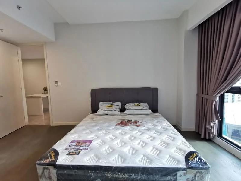 Bedroom features: king-size bed, upholstered headboard, bedding with decorative pillows, floor-to-ceiling window, grey curtains, light wood flooring, white painted walls, nightstand with magazines; style: modern; view: city.