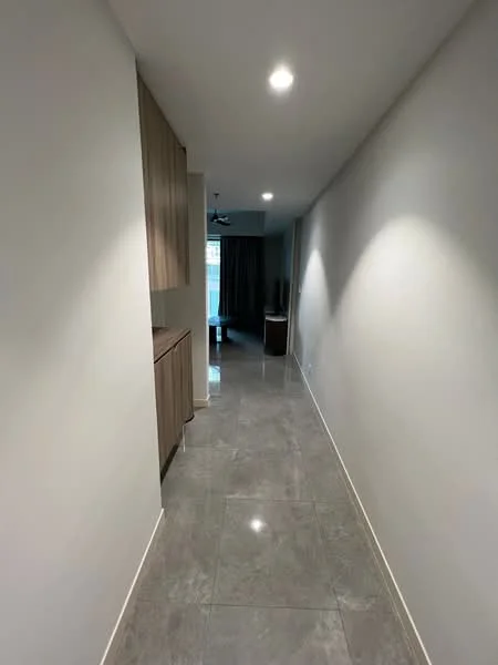 Hallway features: grey marble tile flooring, white painted walls, recessed downlights, wood cabinetry, ceiling fan, curtains, open space leading to living area; style: modern.
