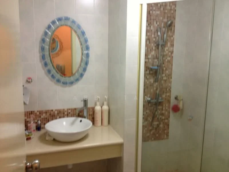 Bathroom features: round vessel sink, chrome basin mixer, wall-mounted mirror with decorative frame, shower area with glass enclosure, rain shower head, handheld shower, tile cladding with mosaic pattern, light-colored wall tiles, vanity countertop, bottles of toiletries on countertop; style: modern.