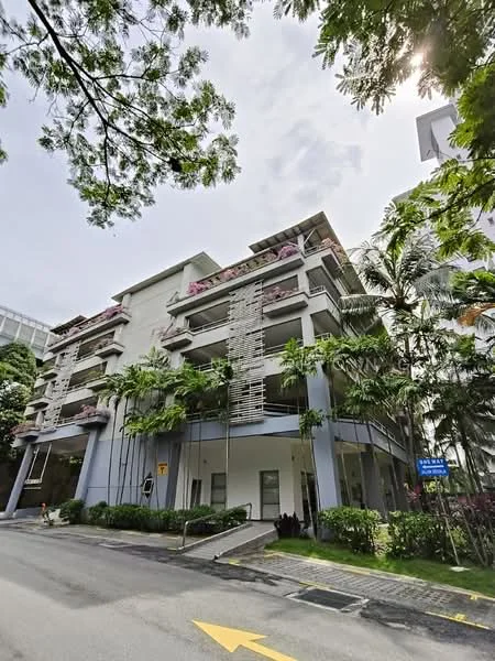 Exterior type: low-rise apartment block; features: white painted facade, recessed balconies with planters, glass railing on balconies, tropical landscaping with palm trees, manicured lawn, paved driveway, signage visible, surrounded by greenery; style: modern.