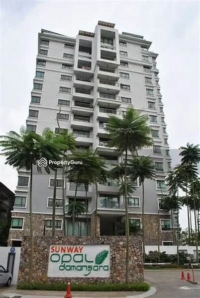 Exterior type: mid-rise condominium; features: grey painted facade, glass windows, recessed balconies, stone cladding at base, palm trees in front, landscaped entrance, signage at entrance, multiple storeys, modern architectural design; style: modern.