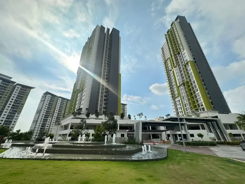 Exterior type: high-rise condominium; features: two tall residential towers, water fountain feature in foreground, manicured lawn, landscaped garden, modern architectural design, glass curtain wall, green accent panels on facade, outdoor seating area, paved walkway, surrounded by greenery; style: modern.