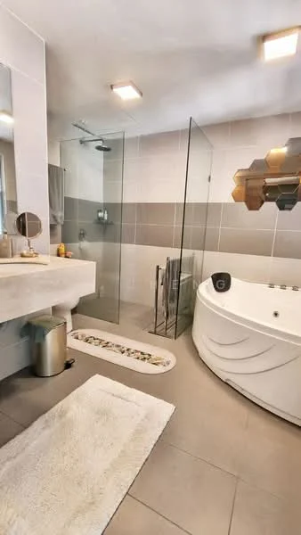 Bathroom features: walk-in shower with glass enclosure, rain shower head, freestanding bathtub, single-sink vanity with stone countertop, round mirror, chrome basin mixer, grey tiled walls, light grey floor tiles, white bath mat, decorative wall art, towel rack, waste bin; style: modern.