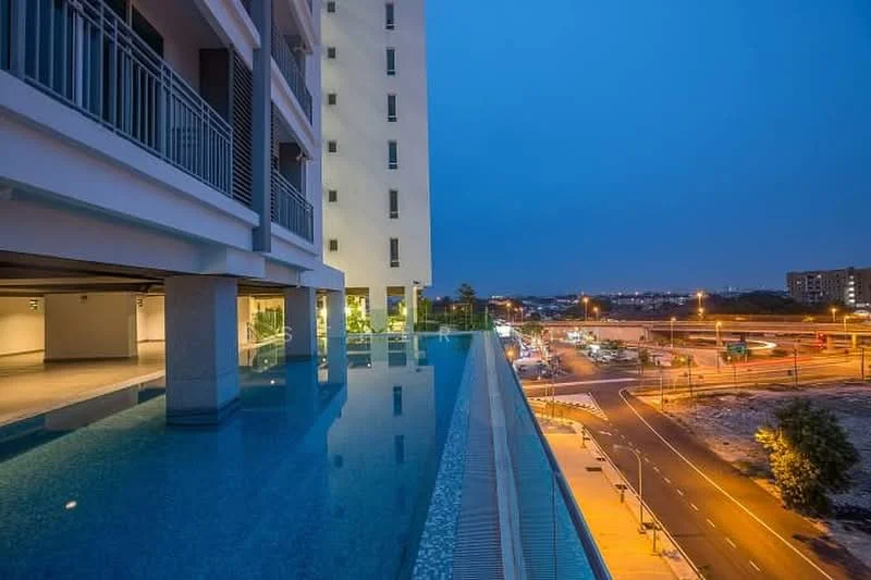 Exterior type: high-rise condominium; features: infinity pool, pool deck, concrete facade, glass railing, surrounding urban landscape, night lighting, road view, manicured landscaping; style: modern.