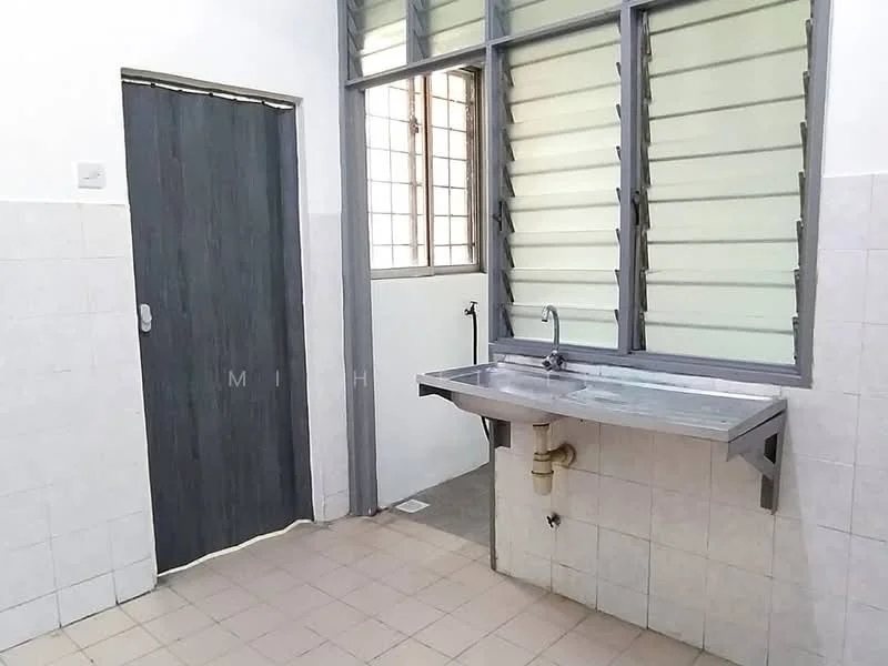 Room features: grey tiled flooring, white tiled walls, metal sink, chrome faucet, window with louvered glass, wooden door, wall-mounted pipe, drainage outlet on floor, countertop with storage underneath; style: minimalist.