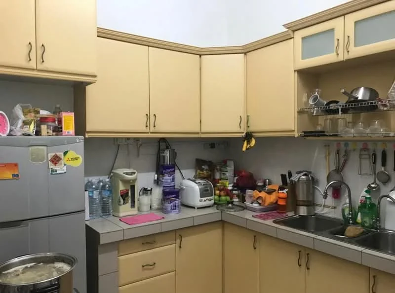 Kitchen features: yellow cabinetry, grey countertop, stainless-steel sink, chrome faucet, built-in microwave, toaster, blender, water dispenser, refrigerator, kitchen utensils on rack, open shelving, various kitchen appliances, tile backsplash, floor tiles, wall-mounted storage.