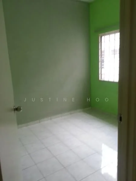 Room features: green painted walls, white tiled flooring, window with bars, natural light from window, plain ceiling, door frame, corner room.