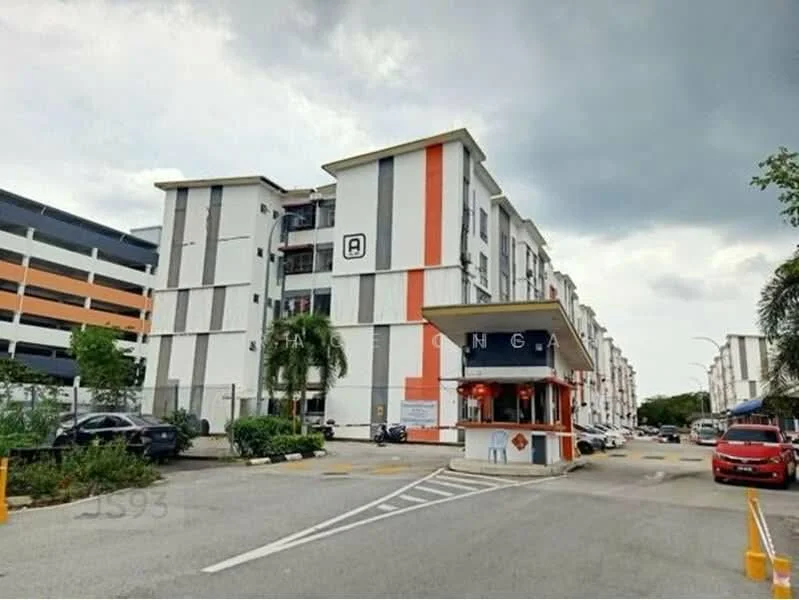Exterior type: low-rise apartment block; features: white painted facade, orange accent stripes, multiple storeys, covered parking area, manicured landscaping, security guardhouse at entrance, driveway with interlocking pavers, surrounded by mature greenery; style: modern.