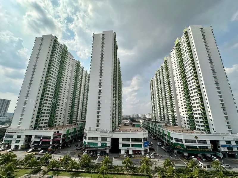Exterior type: high-rise condominium; features: green and white facade, multiple towers, commercial units at ground level, surrounding palm trees, open-air parking area, urban landscape, cloudy sky, manicured landscaping; style: modern.