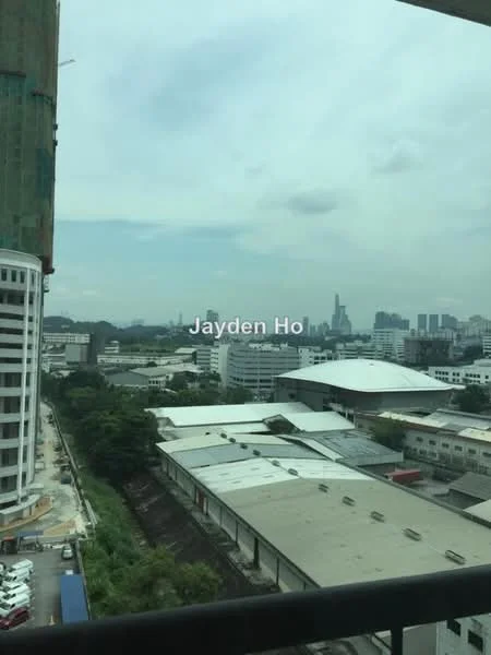 Exterior type: high-rise condominium; features: city skyline view, surrounded by commercial buildings, open-air balcony, construction site visible, urban landscape, multiple rooftops, greenery in the foreground; style: modern.