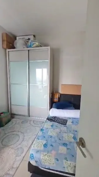 Bedroom features: single bed with blue floral bedding, built-in wardrobe with sliding glass doors, light-colored walls, tile flooring, area rug with circular pattern, window with natural light, box storage on top of wardrobe.
