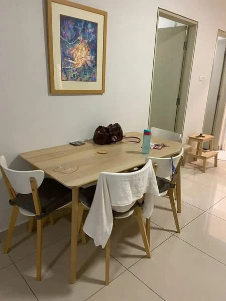 Dining features: wooden dining table, 4 dining chairs with white seats and wooden legs, framed artwork on wall, light-colored walls, tile flooring, water bottle on table, handbag on table, white towel draped over chair; style: modern. Hallway features: light-colored walls, doorway leading to another room, tile flooring.
