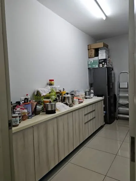 Kitchen features: white painted walls, glossy tile flooring, light wood cabinetry, stainless-steel refrigerator, countertop with various kitchen appliances, stacked boxes on top of cabinets, multiple cooking utensils and containers on countertop, metal shelving unit, overhead fluorescent lighting; style: modern.