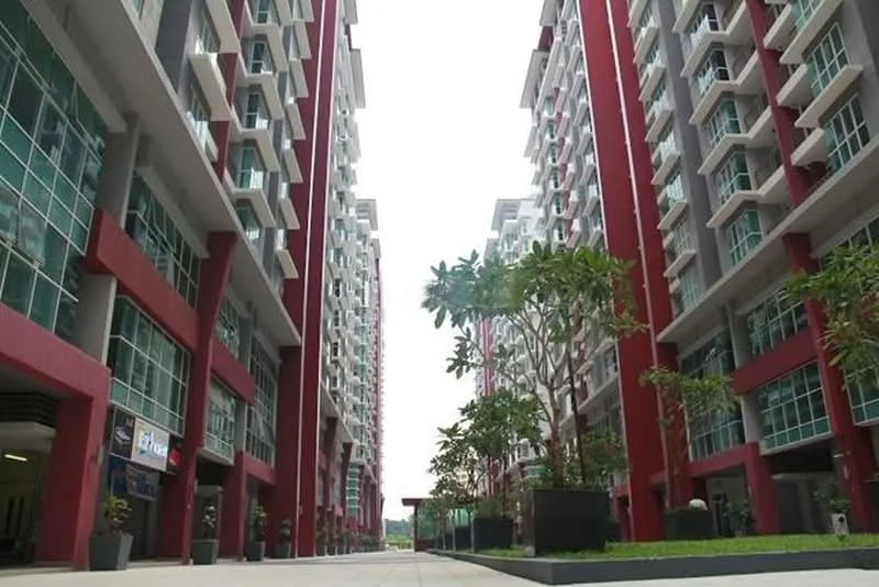 Exterior type: mid-rise condominium; features: red painted facade, glass windows, landscaped planters, paved walkway, multiple storeys, balconies, surrounding greenery; style: modern.