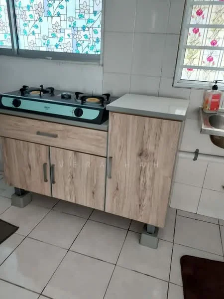 Kitchen features: gas stove with two burners, wooden cabinetry with light wood finish, white countertop, white tiled backsplash, white tiled flooring, sink with faucet, window with stained glass, kitchen mat on floor; style: modern.
