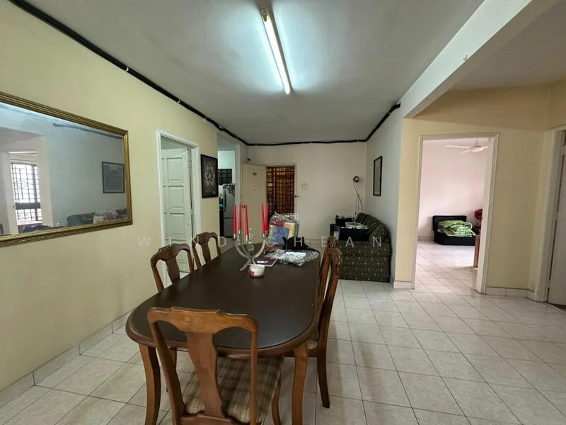 Dining features: rectangular wooden dining table, 6 dining chairs, cream painted walls, tile flooring, ceiling light fixture, mirror on wall, open layout to living area, window with grid pattern; style: traditional. Living features: sofa, green accent cushions, tile flooring, open layout to dining area, natural light from window.