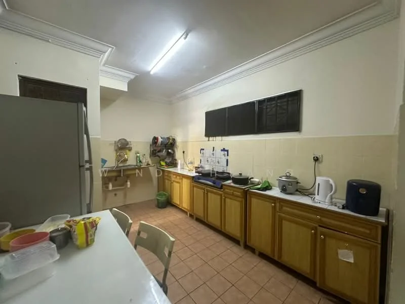 Kitchen features: brown wooden cabinetry, white tiled backsplash, grey countertop, stainless-steel fridge, built-in oven, microwave, kettle, toaster, sink, ceramic tile flooring, ceiling with crown moulding, window with black grille, open shelving, plastic storage containers.