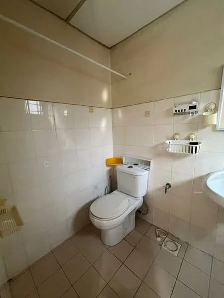 Bathroom features: white tiled walls, cream tiled flooring, one-piece toilet, sink with wall-mounted faucet, mirror above sink, shelf above toilet, toilet paper holder, drain in floor.