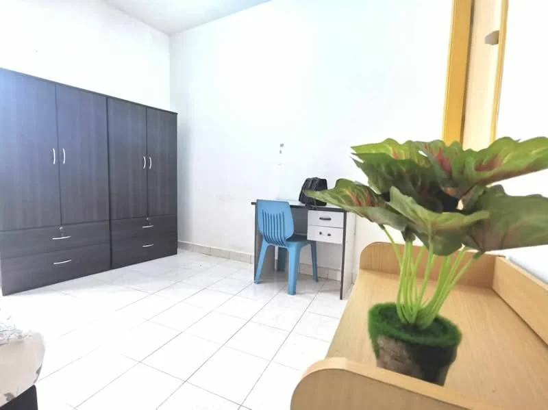 Room features: white painted walls, tile flooring, built-in wardrobe with dark wood finish, study desk with drawer, blue plastic chair, decorative plant on shelf, window with natural light, minimalist decor; style: modern.