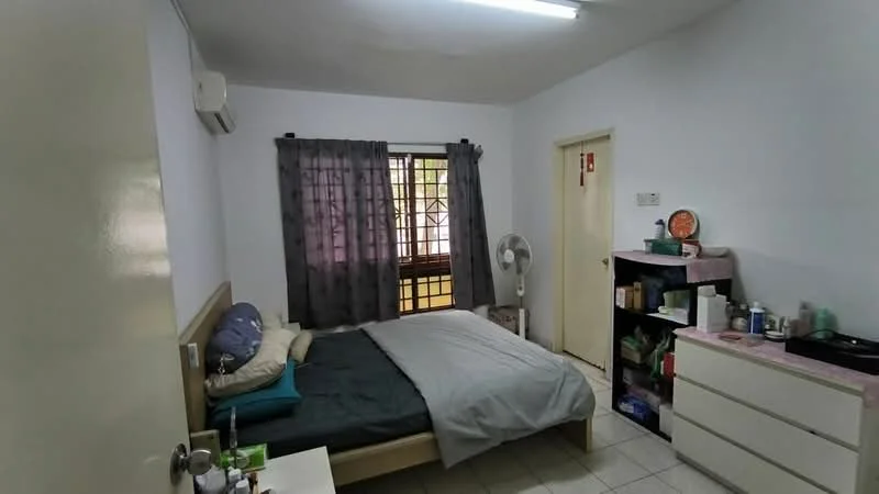 Bedroom features: queen-size bed with grey bedding, white painted walls, tile flooring, window with black curtains, wall-mounted air conditioning unit, ceiling light fixture, standing fan, built-in wardrobe, dresser with various items, door leading to hallway.
