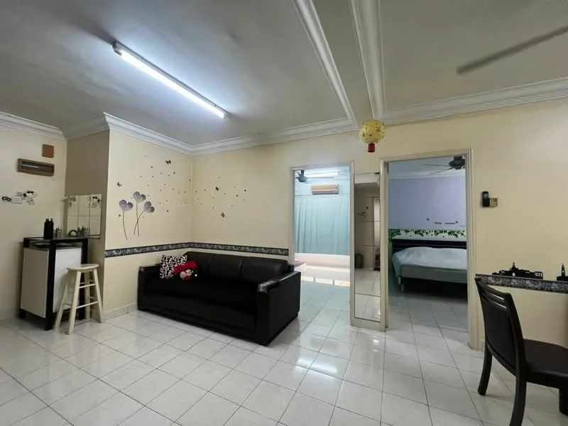 Living features: black fabric sofa, white tiled flooring, cream painted walls, crown moulding, wall-mounted air conditioning unit, decorative wall decals, small side table, mirror, light fixture with fluorescent lights; style: modern. Bedroom features: double bed with white bedding, light green curtains, wall-mounted air conditioning unit, wooden flooring, decorative wall with floral pattern; style: modern.