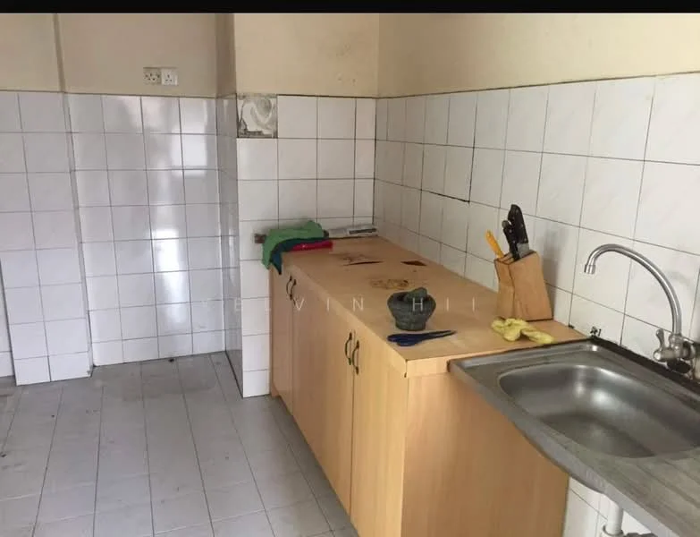 Kitchen features: laminate countertop, stainless-steel sink, chrome faucet, wood cabinetry, white tiled walls, grey tiled flooring, knife block, cleaning cloth, kitchen utensils.