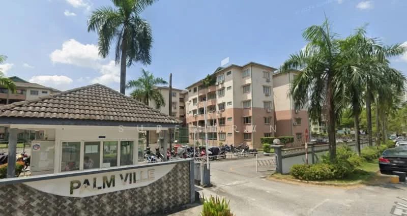 Exterior type: low-rise apartment block; features: gated entrance, guard house at entrance, palm trees, manicured lawn, parking area with motorcycles, multi-storey building, balconies on upper floors, stone-cladding wall at entrance, signage with 'PALM VILLE'; style: modern.