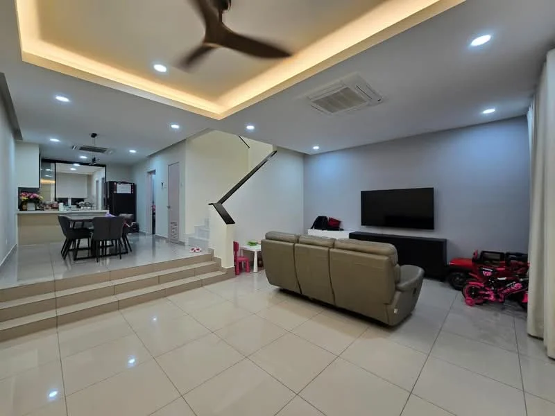 Living features: 3-seater leather sofa in grey, coffee table, wall-mounted TV, recessed downlights, 5-blade ceiling fan, white painted walls, glossy tile flooring, open layout to kitchen, staircase with modern railing, decorative children's toys; style: modern. Kitchen features: kitchen island, stainless-steel appliances, open-plan layout, white cabinetry, black countertop; style: modern.