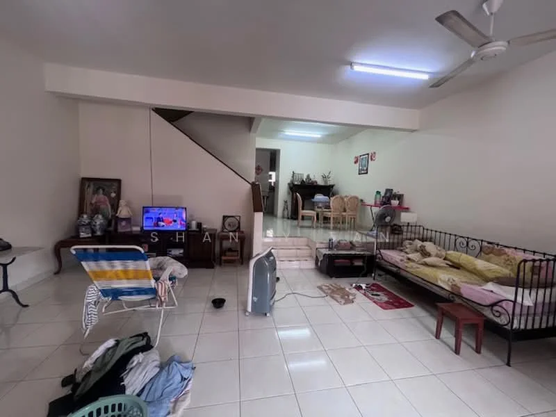 Living features: white painted walls, glossy tile flooring, ceiling fan, wall-mounted TV, sofa bed with bedding, coffee table, dining table with chairs, decorative wall art, staircase leading to upper floor, open layout, area rug, laundry items on the floor; style: modern.