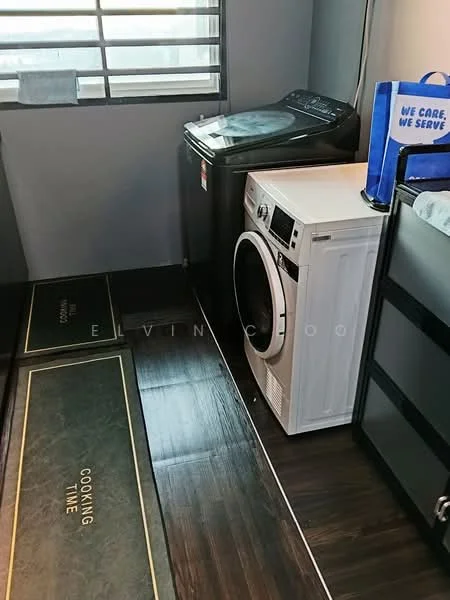 Laundry features: front-load washing machine, tumble dryer, dark wood laminate flooring, grey painted walls, window with horizontal bars, two floor mats with text, white cabinetry, black laundry basket; style: modern.