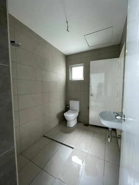 Bathroom features: grey tiled walls, white ceramic floor tiles, single-piece toilet, shower with wall-mounted shower head, small window for natural light, white sink with chrome faucet, mirror above sink, door to bathroom, ceiling with recessed lighting; style: modern.