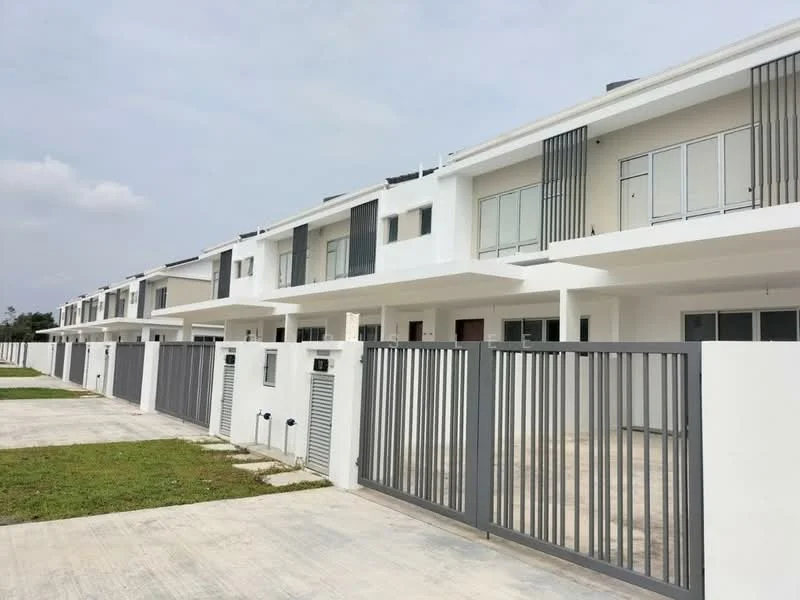 Exterior type: linked terrace house; features: white painted facade, flat roof, two-storey structure, horizontal metal railings on balconies, concrete driveway, manicured lawn, fenced perimeter, multiple units in a row, large windows, front porch area; style: modern.