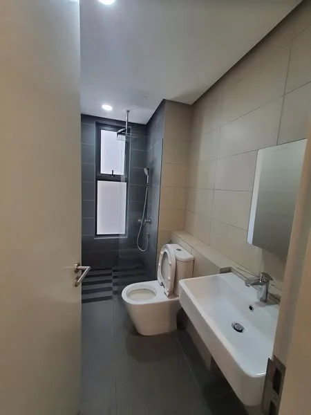 Bathroom features: grey tiled walls, white ceramic toilet, single-sink vanity with white countertop, chrome basin mixer faucet, framed mirror, walk-in shower with glass enclosure, rain shower head, sliding window, grey tiled flooring, recessed downlights; style: modern.