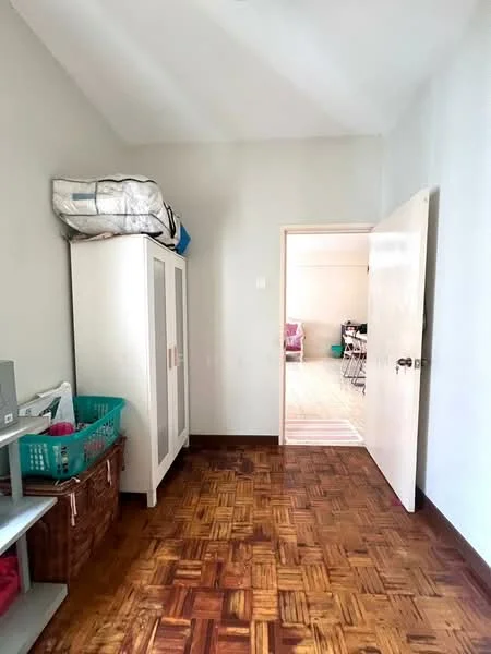 Room features: light grey painted walls, wooden parquet flooring, white wardrobe with sliding doors, open shelving unit, basket for storage, door leading to another room.