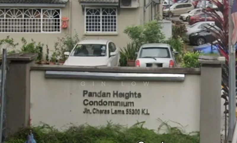 Exterior type: condominium; features: signage with 'Pandan Heights Condominium', two parked cars, landscaped area with plants, fenced boundary, windows with grilles, entrance gate, paved driveway; style: modern.